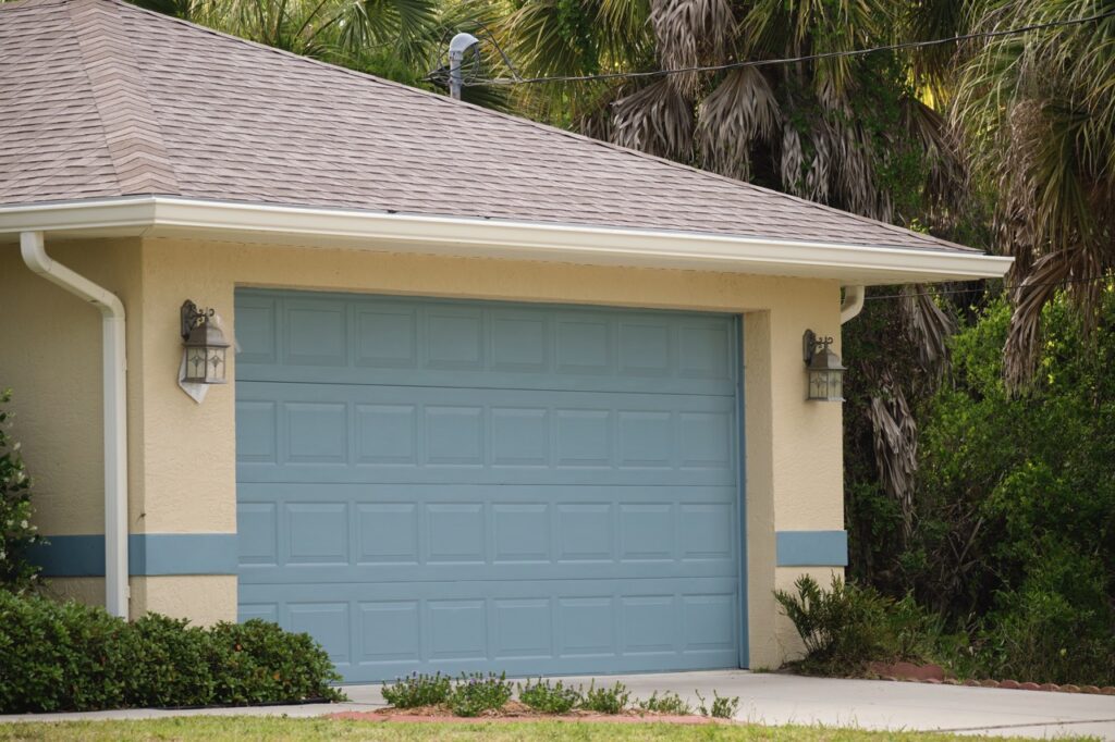 Single-family home with a blue garage door and beige exterior walls.